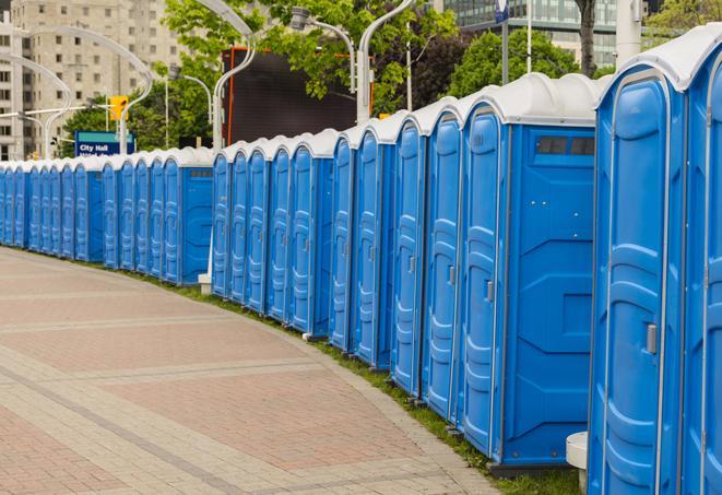 portable restrooms with sink and hand sanitizer stations, available at a festival in Cataumet